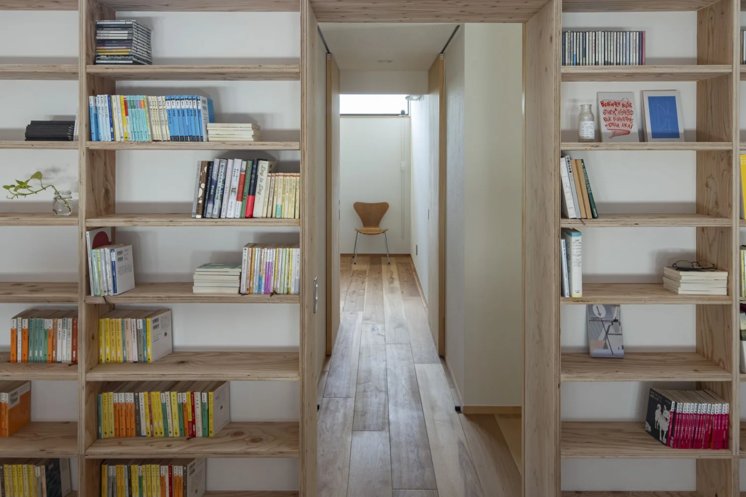 Pass through a tunnel of bookshelves into a compact private room.