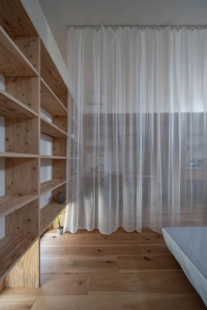 View of the workspace through the curtain from the sleeping area.