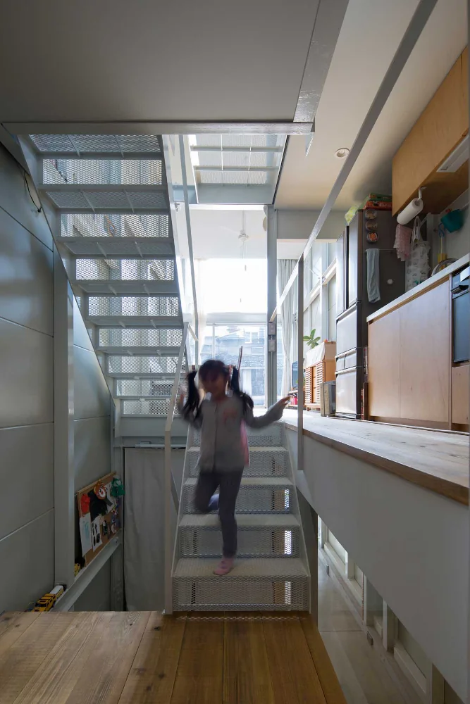 View from the children’s room toward the LDK and kitchen.｜Narrow Skip-Floor Steel-Frame Garage House | ' ' House