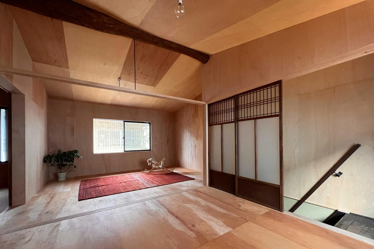 While the first floor emphasizes wet finishes such as paint and plaster, the second floor is finished with plywood and dry-system treatments.