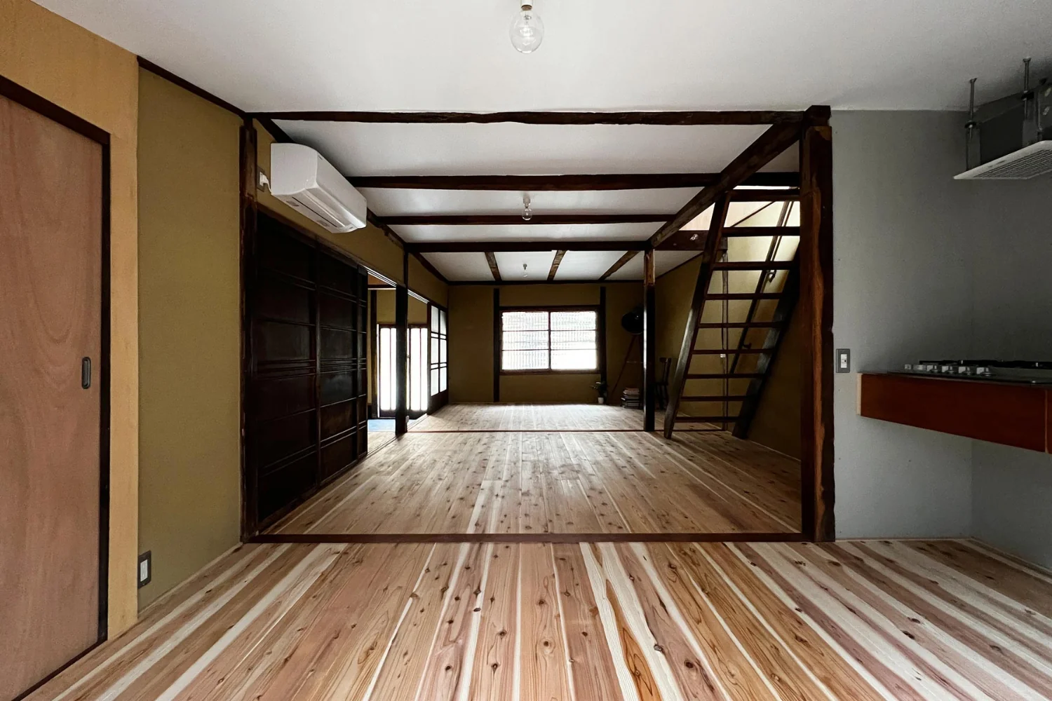 View from the east to the west of the living room. In the near left is the washbasin and bathroom.｜Layering a Studio Apartment and a Traditional Kyoto Townhouse — Row House III on Showa Lane