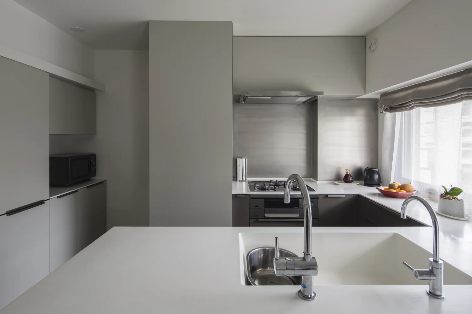 The wall behind the kitchen was furred out to accommodate supply/drain plumbing and ventilation routes.