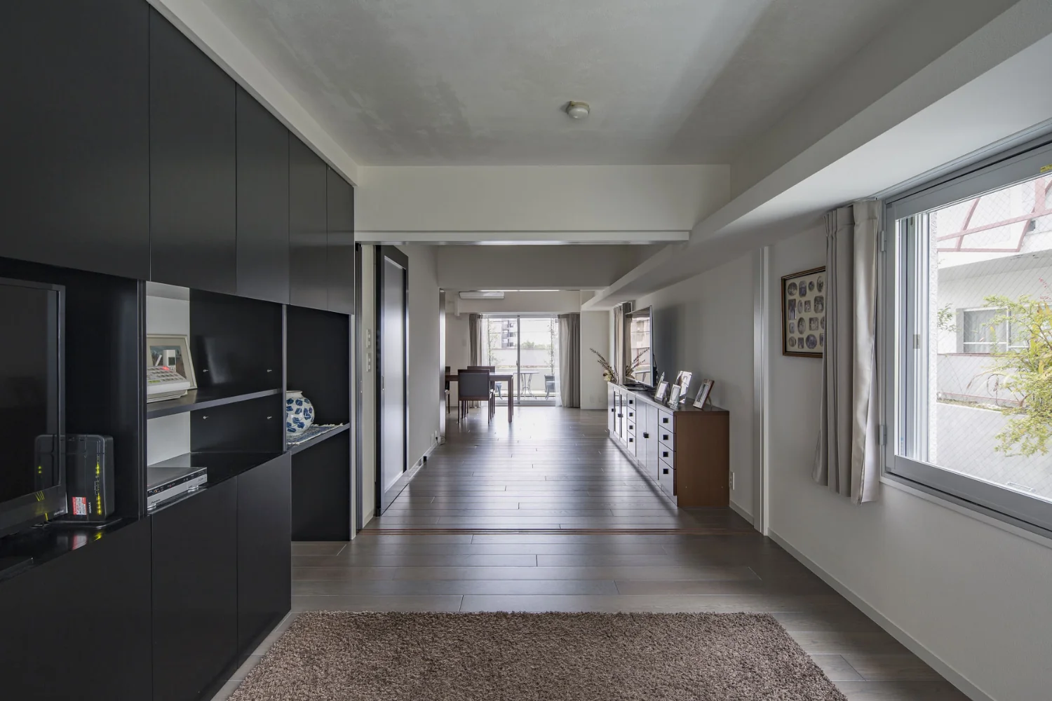 Spray‑applied polyurethane foam was applied to exterior wall surfaces and secondary glazing was installed at openings to improve thermal insulation, airtightness, and sound insulation.