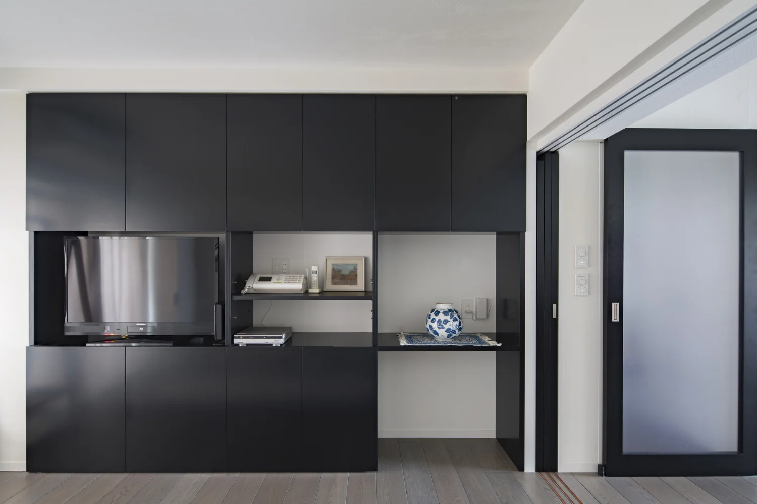 Custom joinery housing documents and AV equipment.