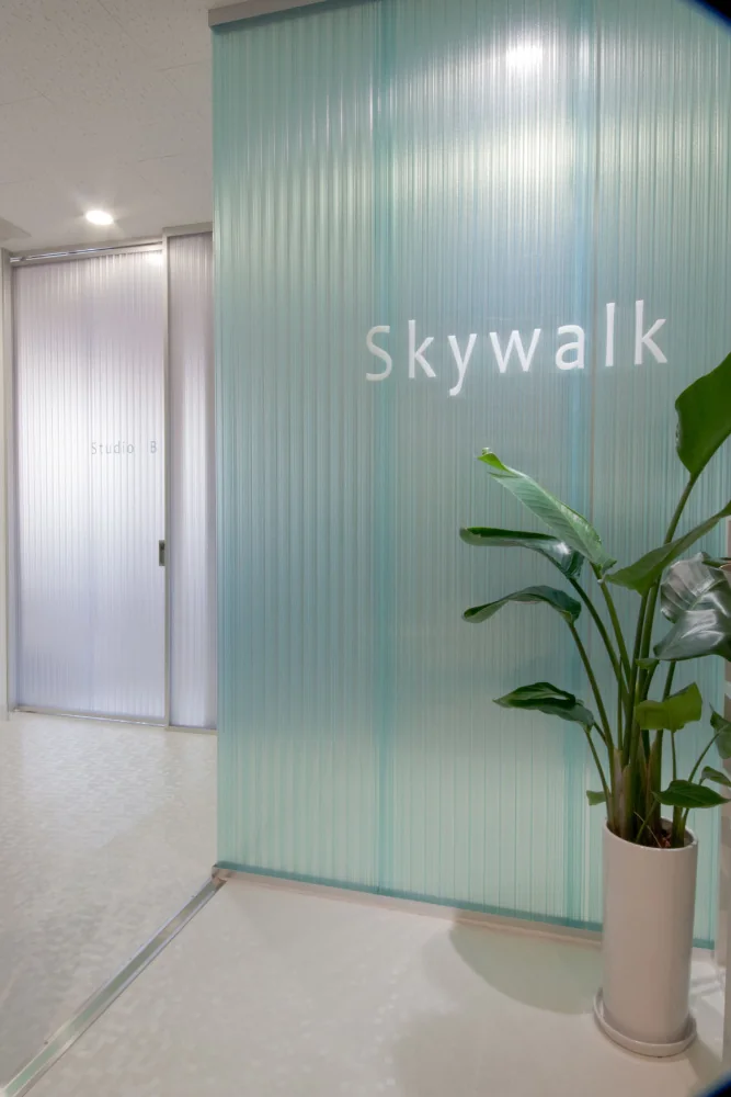 The entrance sign is laser-cut from milky translucent acrylic and sandblasted to achieve a matte finish.