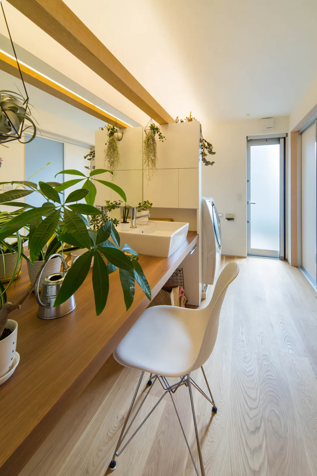 A multifunctional space accommodating household chores, family restroom, laundry, makeup room, and indoor drying area.