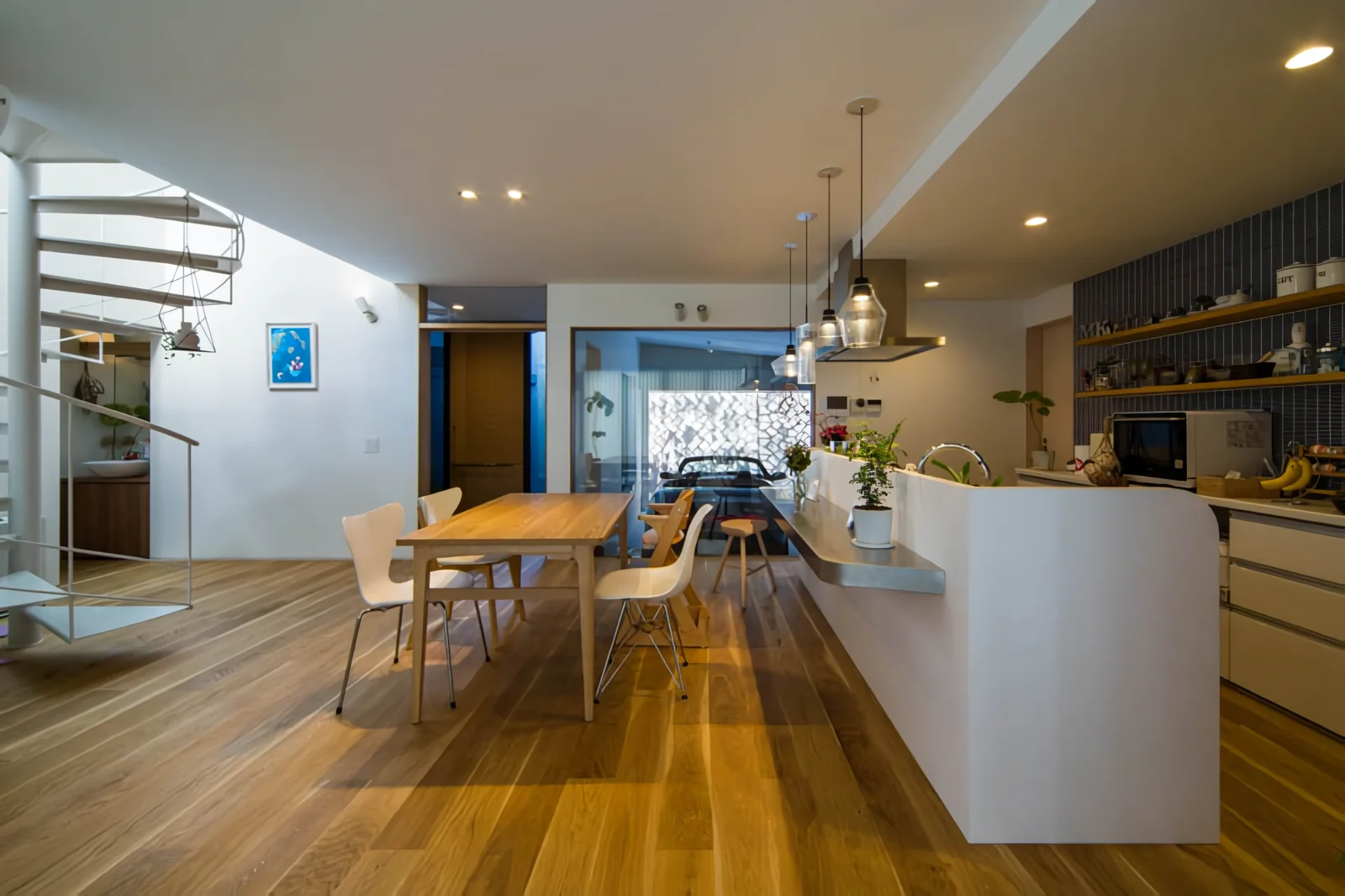 Light from the atrium of the spiral staircase illuminates the north side of the living-dining-kitchen area.