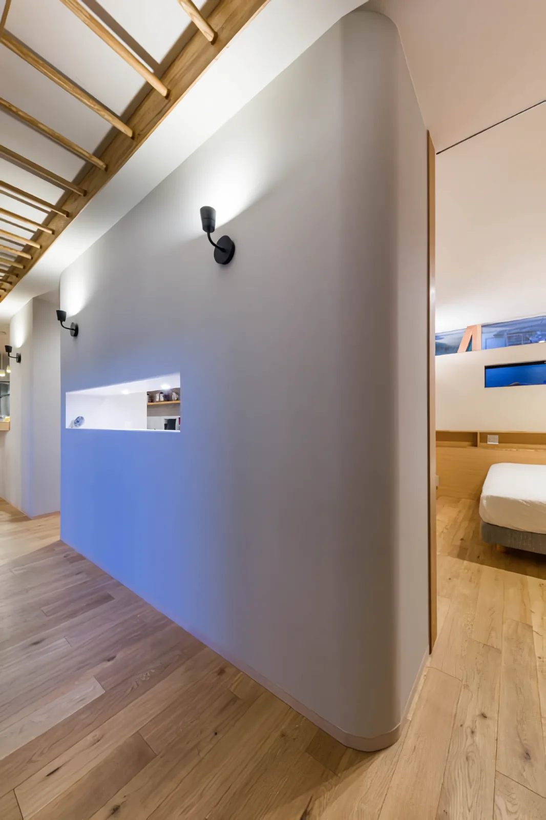 Corridor facing the courtyard; beyond the slit opening lies the utility space.