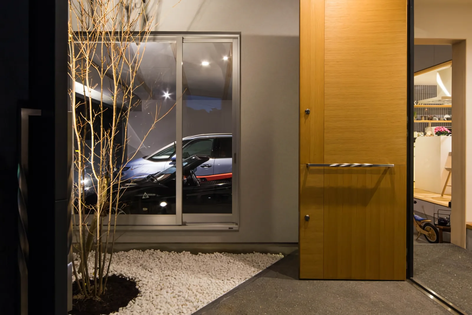 The inner garage is framed like a gallery, visible from the entrance court.