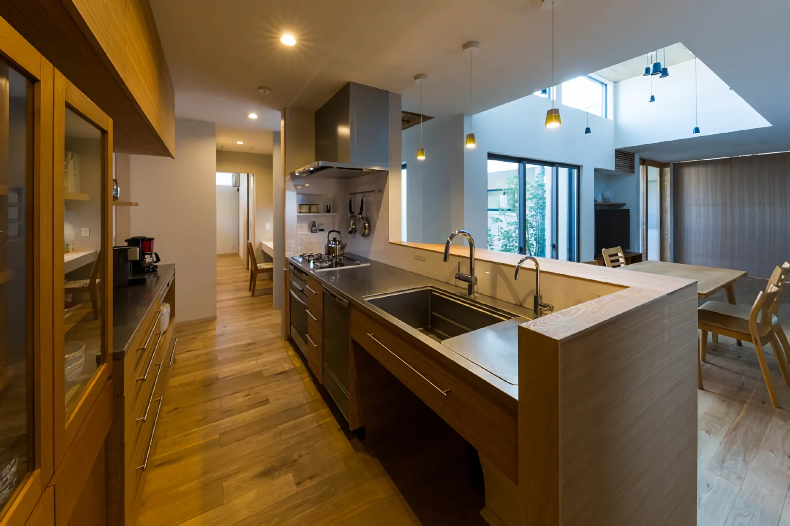 Passing through the kitchen leads to the utility space, which further connects seamlessly to the master bedroom beyond.