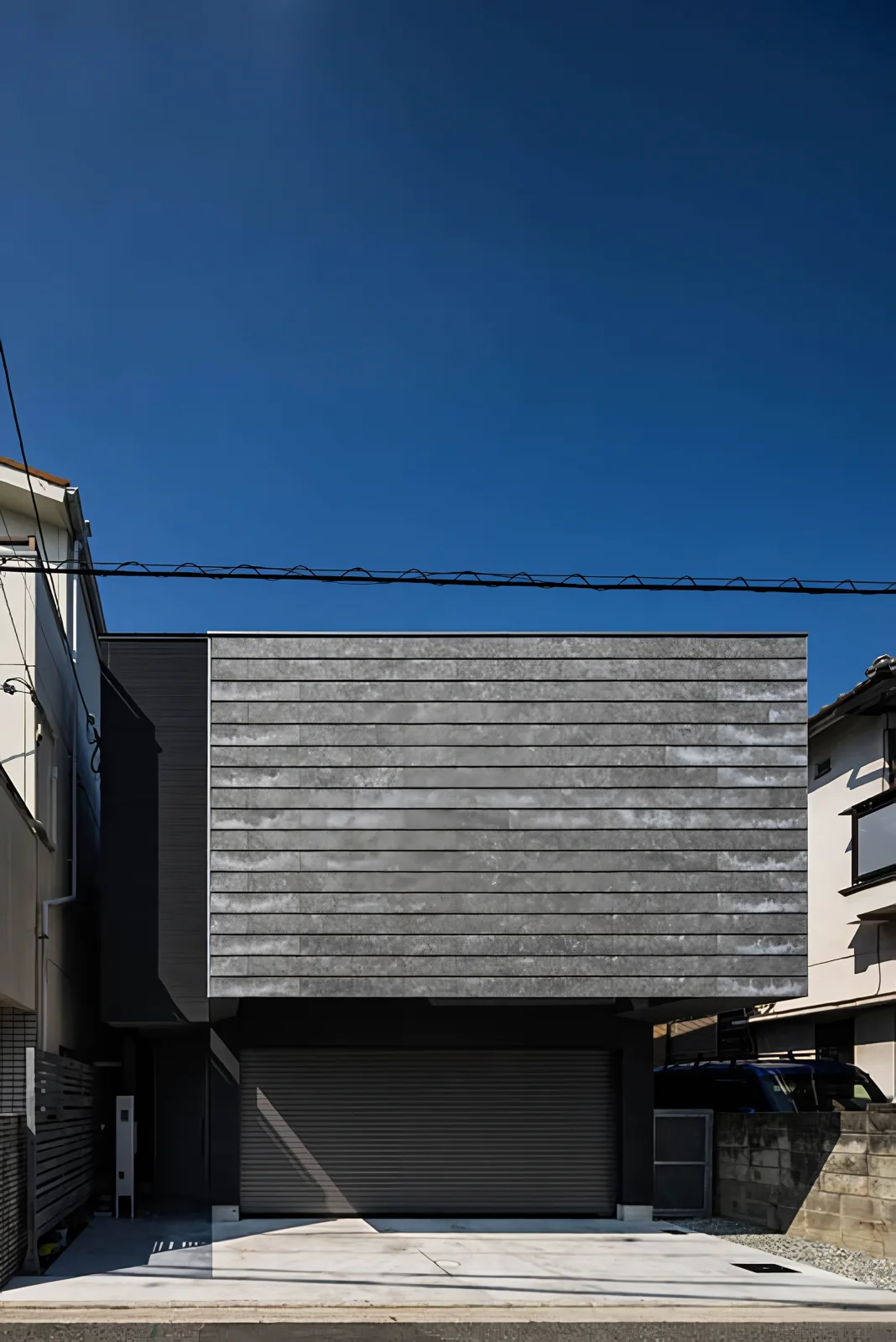 The facade facing the street lacks typical residential architectural vocabulary.