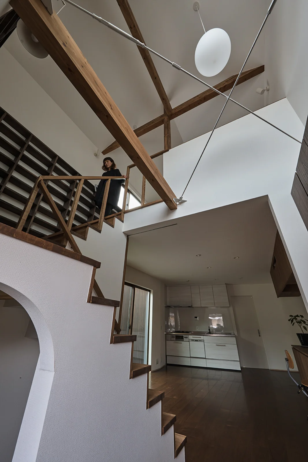 The entrance hall is greeted by bookshelves that connect the first and second floors.