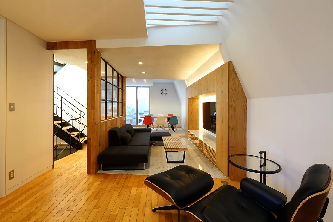 Natural light entering through the top skylight cascades down to illuminate the second-floor LDK space.