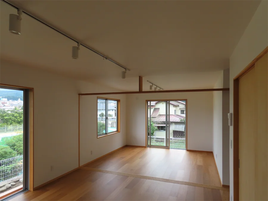 House on a Sloped Site with a Bridge
