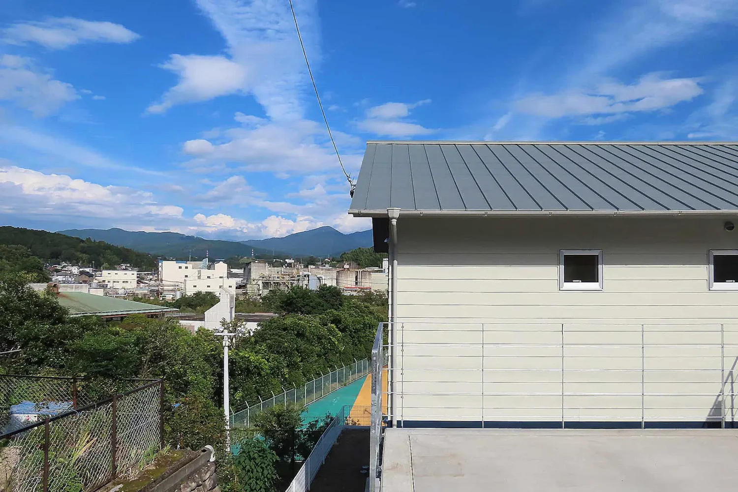 House on a Sloped Site with a Bridge