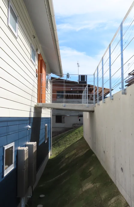 House on a Sloped Site with a Bridge